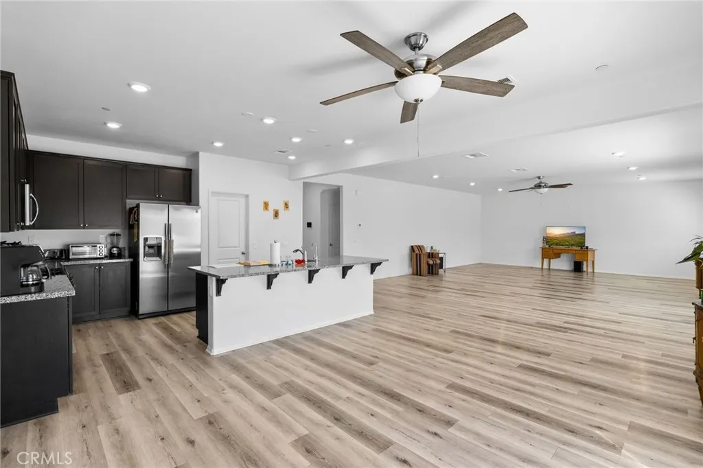 12487 Sunset Road Victorville, CA 92392 - Photo 21 of 44 a living room with furniture and kitchen view