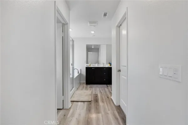 a spacious bathroom with a bathtub shower sink vanity and mirror