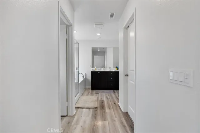 a spacious bathroom with a bathtub shower sink vanity and mirror