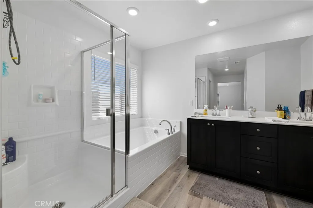 12487 Sunset Road Victorville, CA 92392 - Photo 31 of 44 a spacious bathroom with a bathtub shower sink vanity and mirror