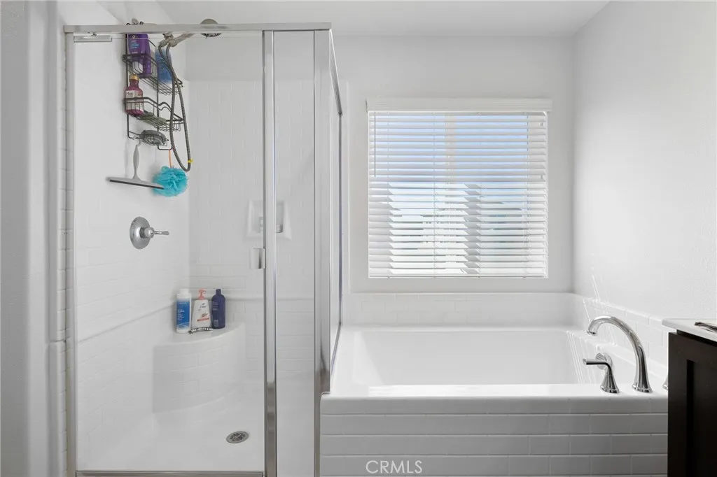 12487 Sunset Road Victorville, CA 92392 - Photo 34 of 44 a bathroom with a bathtub and shower