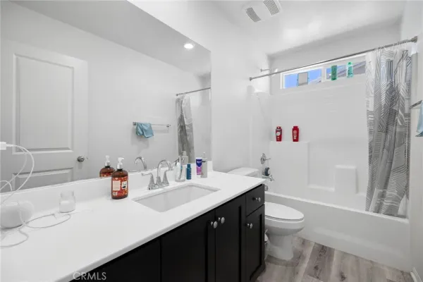 a big yard with a large tree in front of it