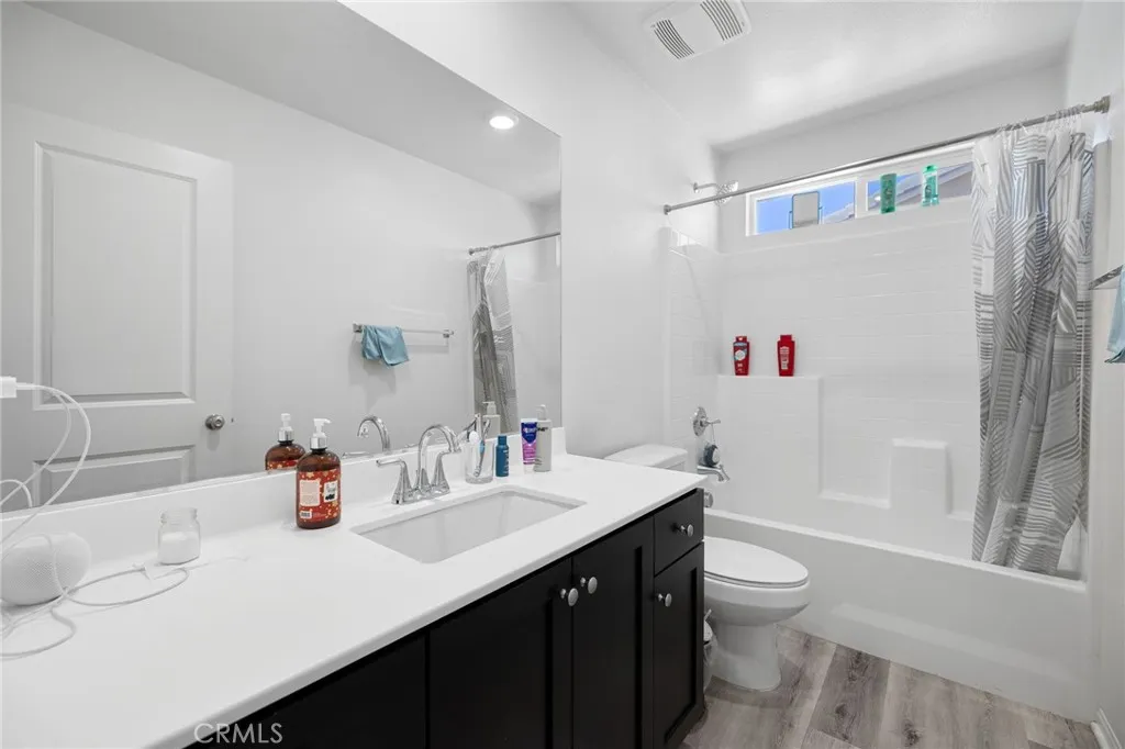 12487 Sunset Road Victorville, CA 92392 - Photo 39 of 44 a bathroom with a sink a toilet and a large mirror
