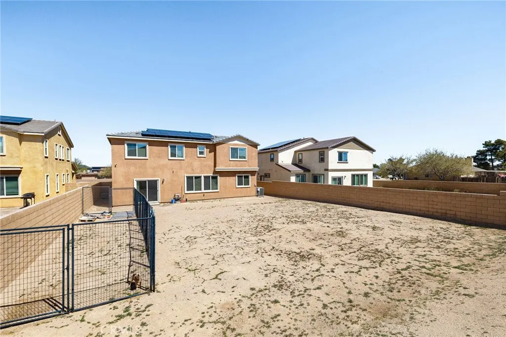 12487 Sunset Road Victorville, CA 92392 - Photo 42 of 44 a front view of a house with a yard