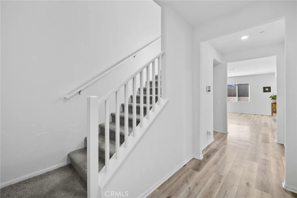 12487 Sunset Road Victorville, CA 92392 - Photo 6 of 44 a view of a hallway with wooden floor and entryway