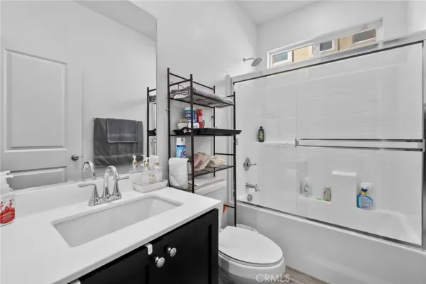 a view of empty room with wooden floor and window