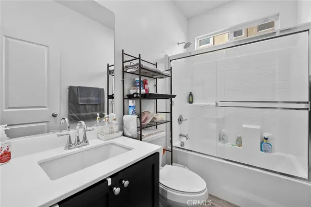 a view of empty room with wooden floor and window