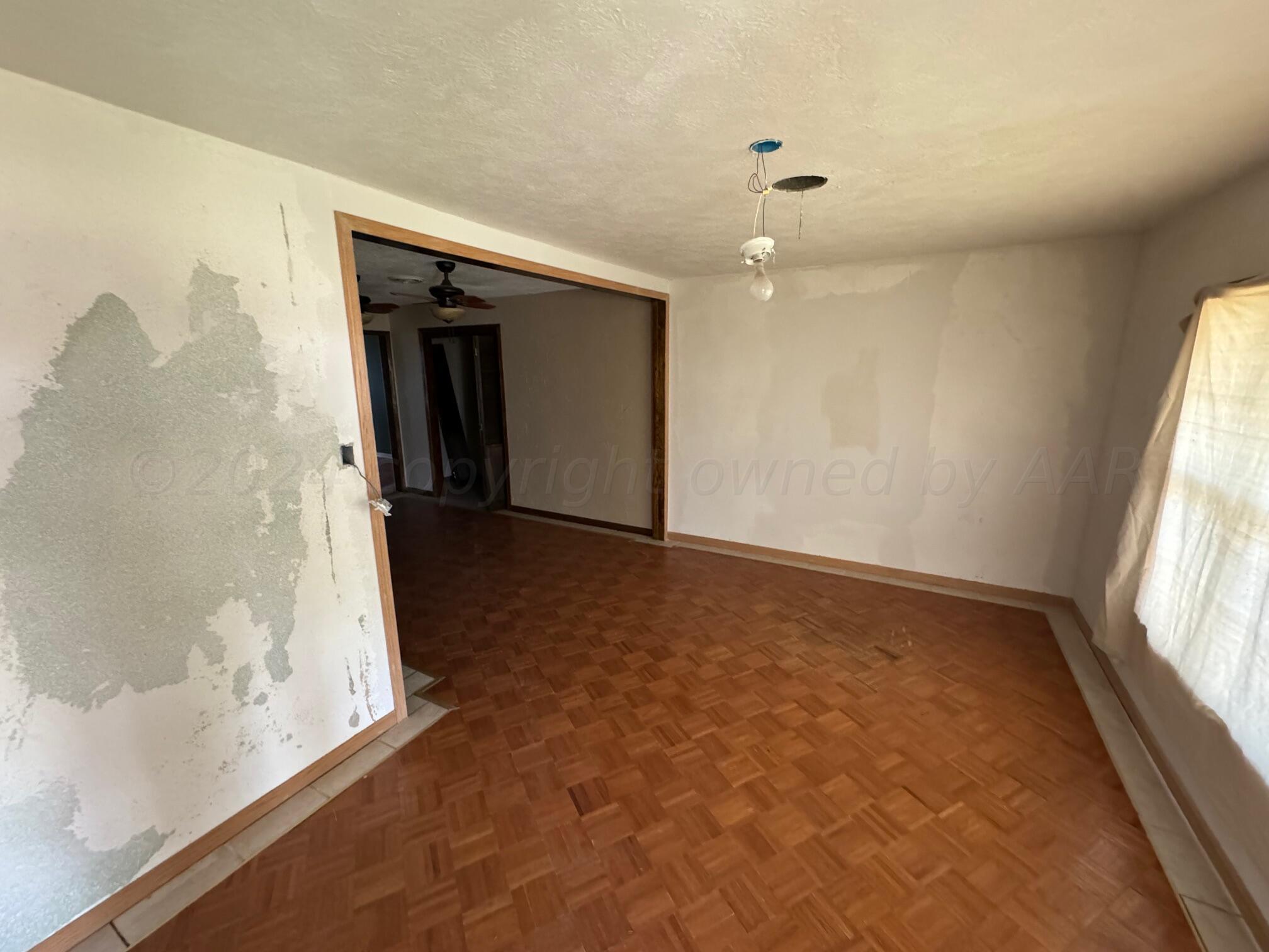 80 Chattanooga Road Amarillo, TX 79118 - Photo 3 of 33 wooden floor in an empty room with a window