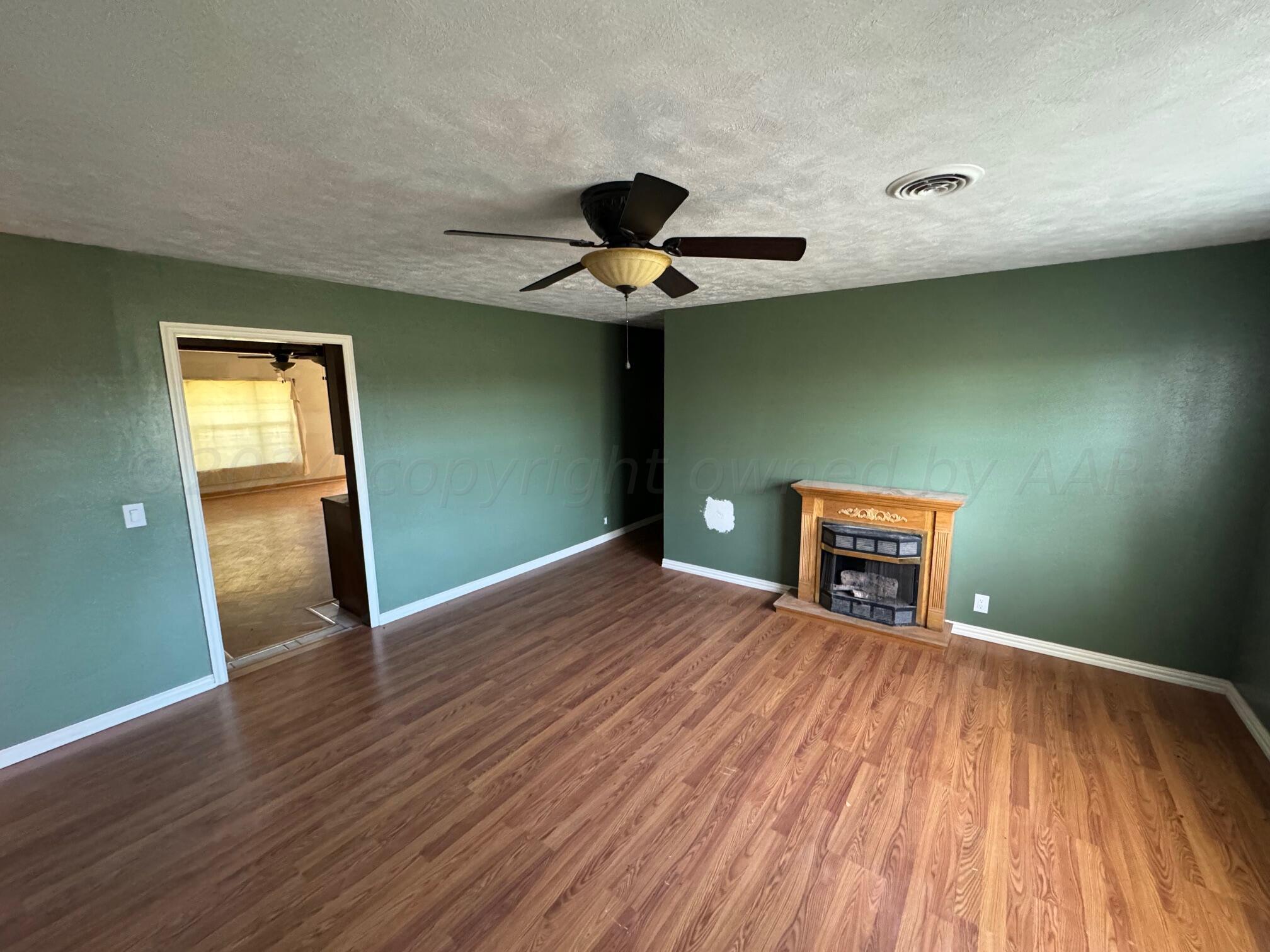 80 Chattanooga Road Amarillo, TX 79118 - Photo 6 of 33 a view of an empty room with a window and wooden floor