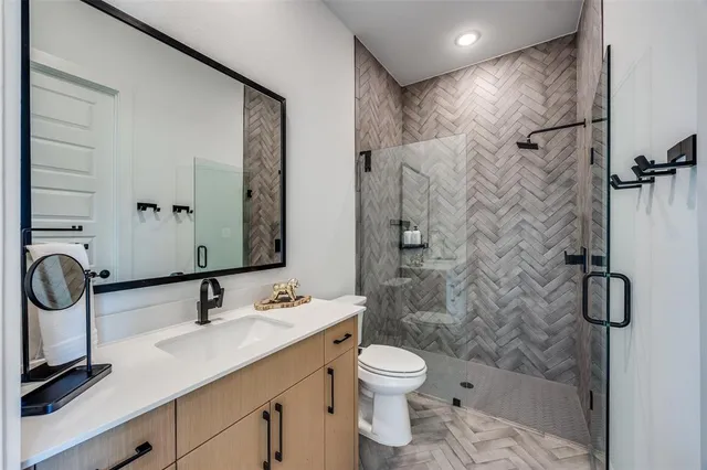 a bathroom with a sink toilet and shower