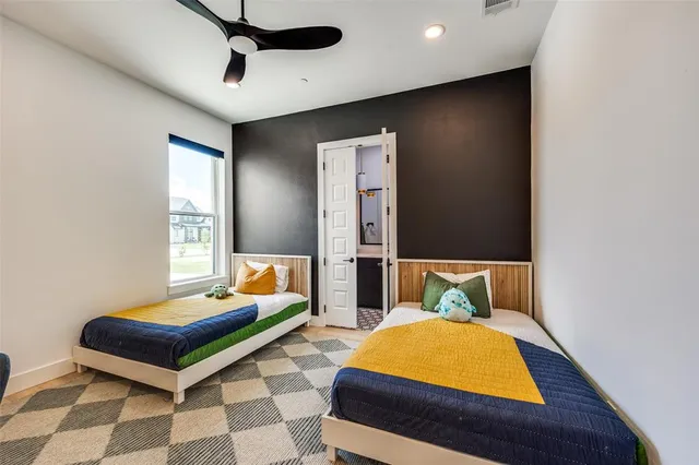 a bedroom with two beds and painted walls