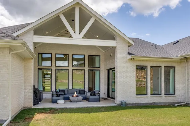 a front view of house with outdoor seating and yard