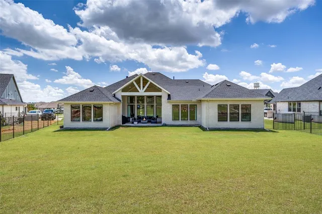 a front view of a house with yard and green space