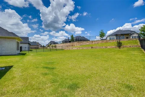 a view of a swimming pool with lawn chairs under an umbrella