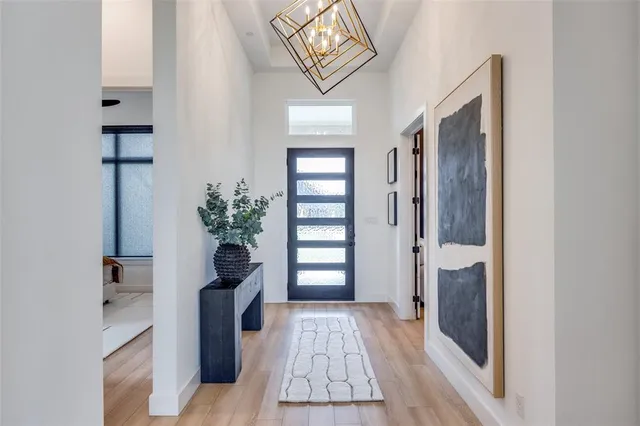 a hallway with front door wooden floor and front door