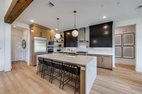 a large kitchen with a table and chairs