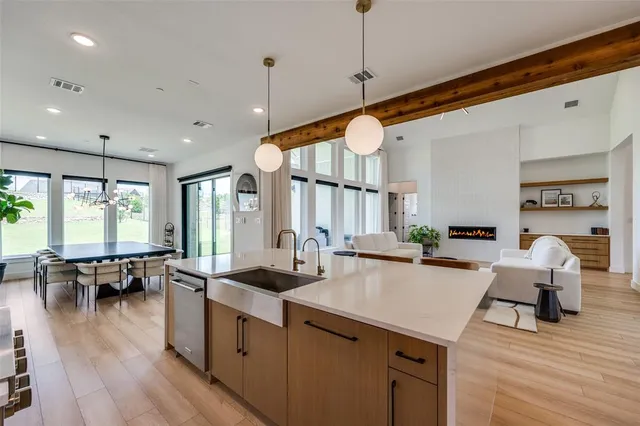 a open kitchen with stainless steel appliances granite countertop a stove and white cabinets with wooden floor