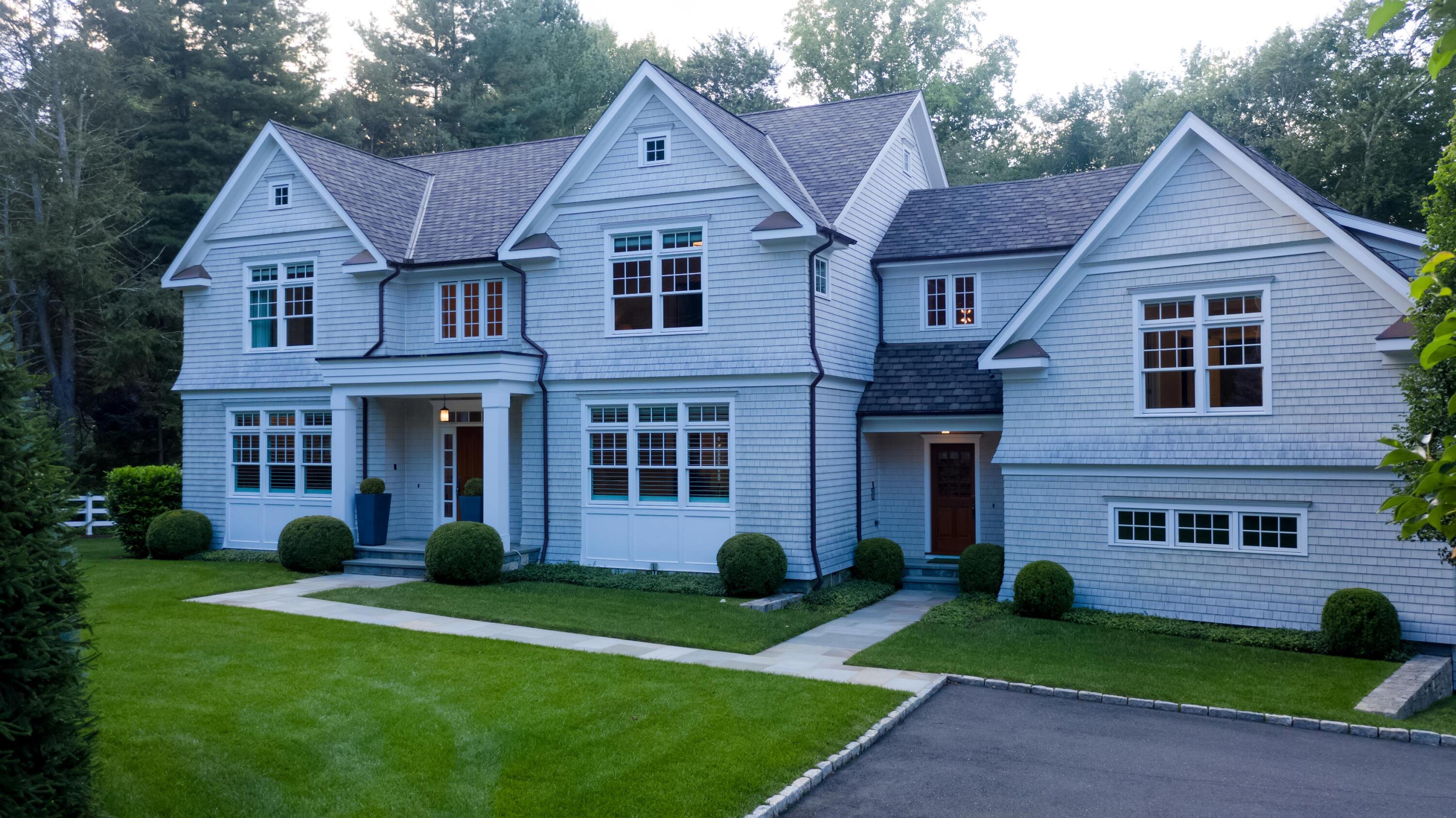 275 Middlesex Road Darien, CT 06820 - Photo 59 of 64 a view of a yard in front of a brick house with plants and large tree