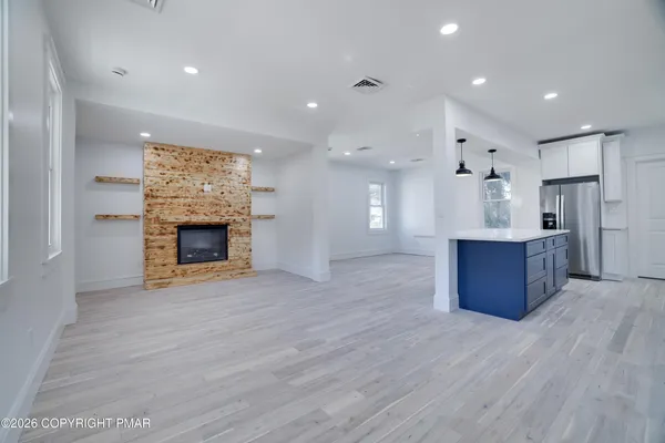 a view of a kitchen with a sink and a refrigerator