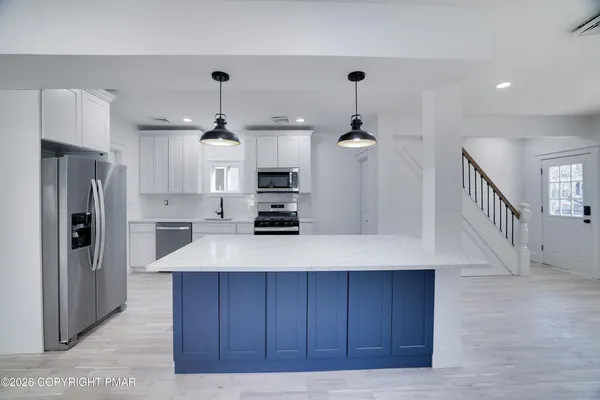 a view of a kitchen with a sink and an oven