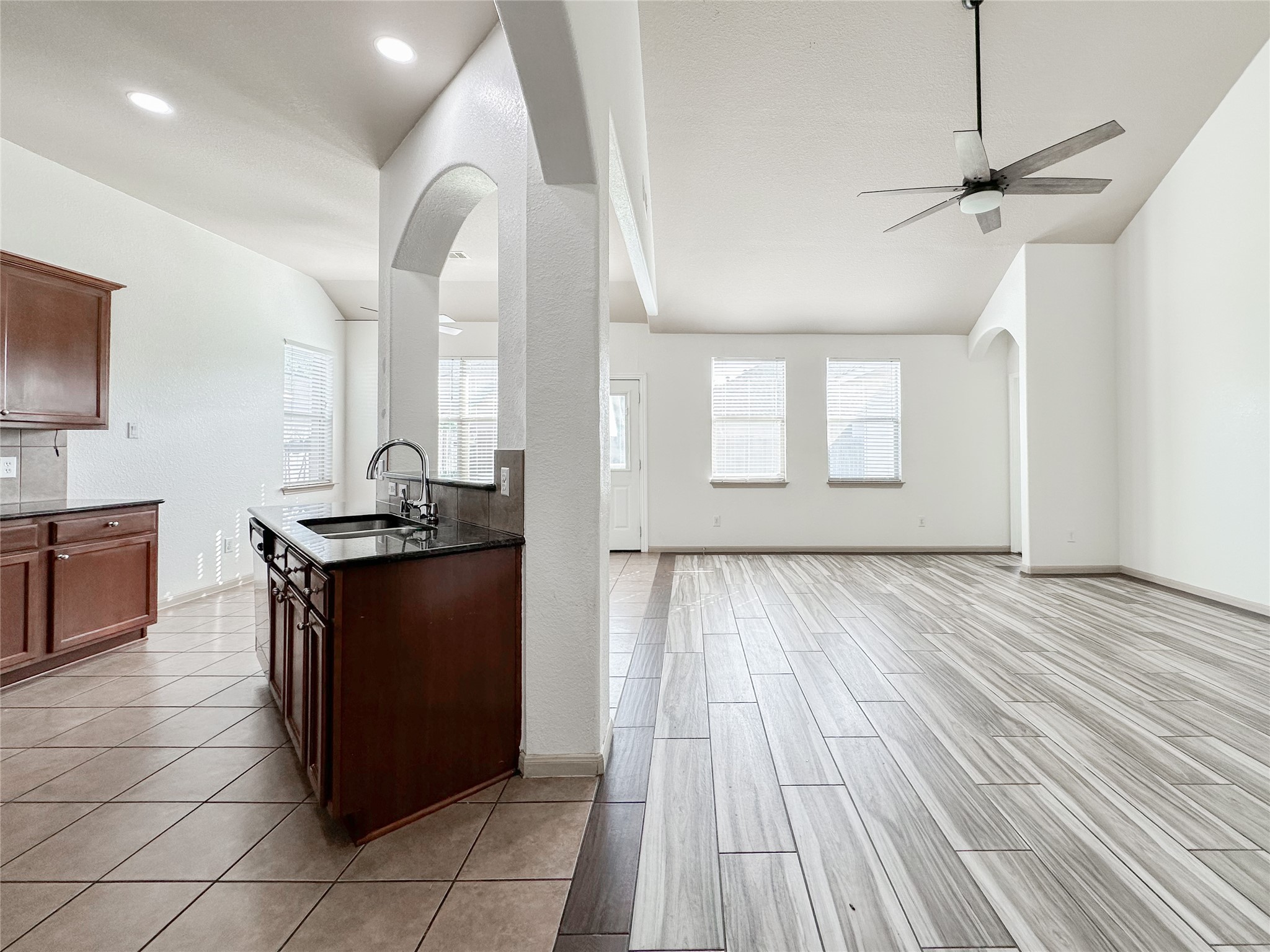 20319 Little Wing Drive Spring, TX 77388 - Photo 17 of 49 a kitchen with granite countertop a stove and a wooden floors