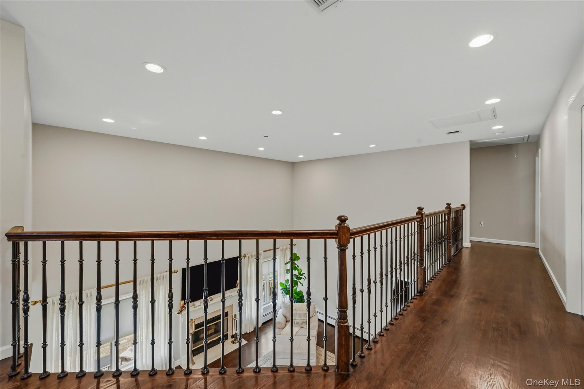 51 Meriwether Trail Congers, NY 10920 - Photo 21 of 50 Hardwood flooring throughout the upper level landing, featuring a wrought iron and wood banister overlooking the space below