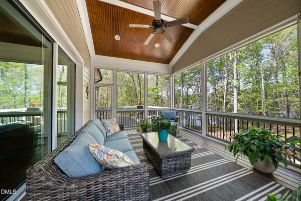 a living room with furniture and floor to ceiling windows