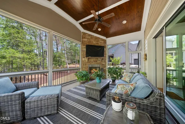 a living room with furniture fireplace and a large window