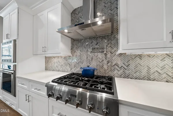 a stove top oven sitting inside of a kitchen