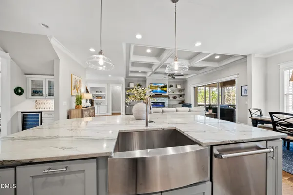 a kitchen with stainless steel appliances granite countertop a sink a stove and a wooden floors