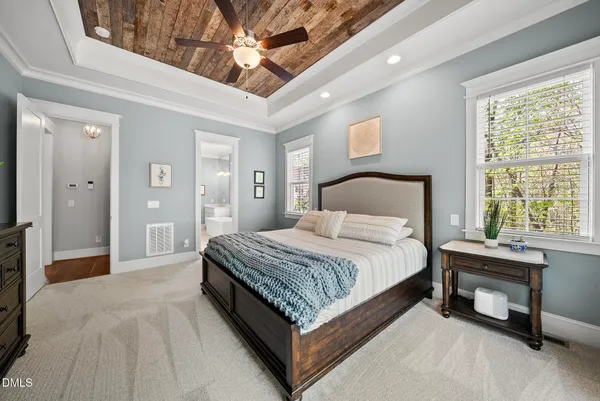 a spacious en suite bathroom with a double vanity sink mirror and shower