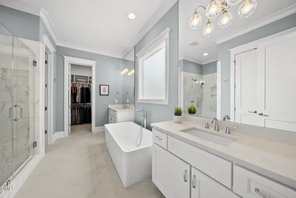a en suite bathroom with a double vanity sink and a mirror