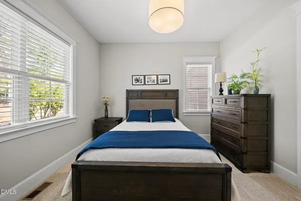 a bed room with a bed and a chandelier