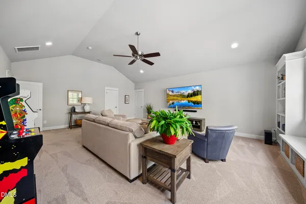 a view of a patio with table and chairs potted plants and floor to ceiling window