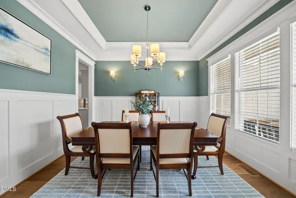 a view of a dining room with furniture and chandelier