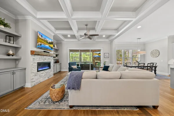 a living room with furniture large window and a fireplace