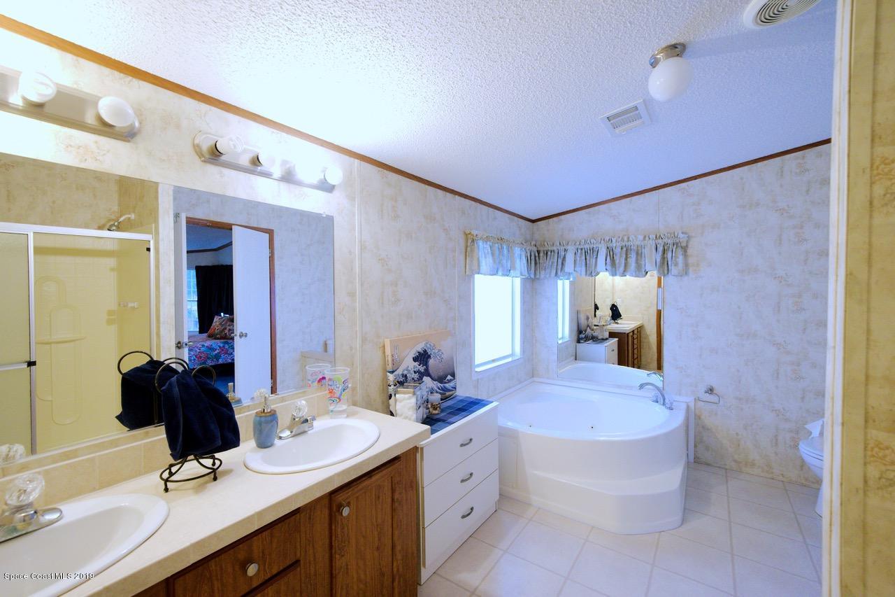 485 Baker Road Merritt Island, FL 32953 - Photo 22 of 28 a bathroom with a tub sink and mirror