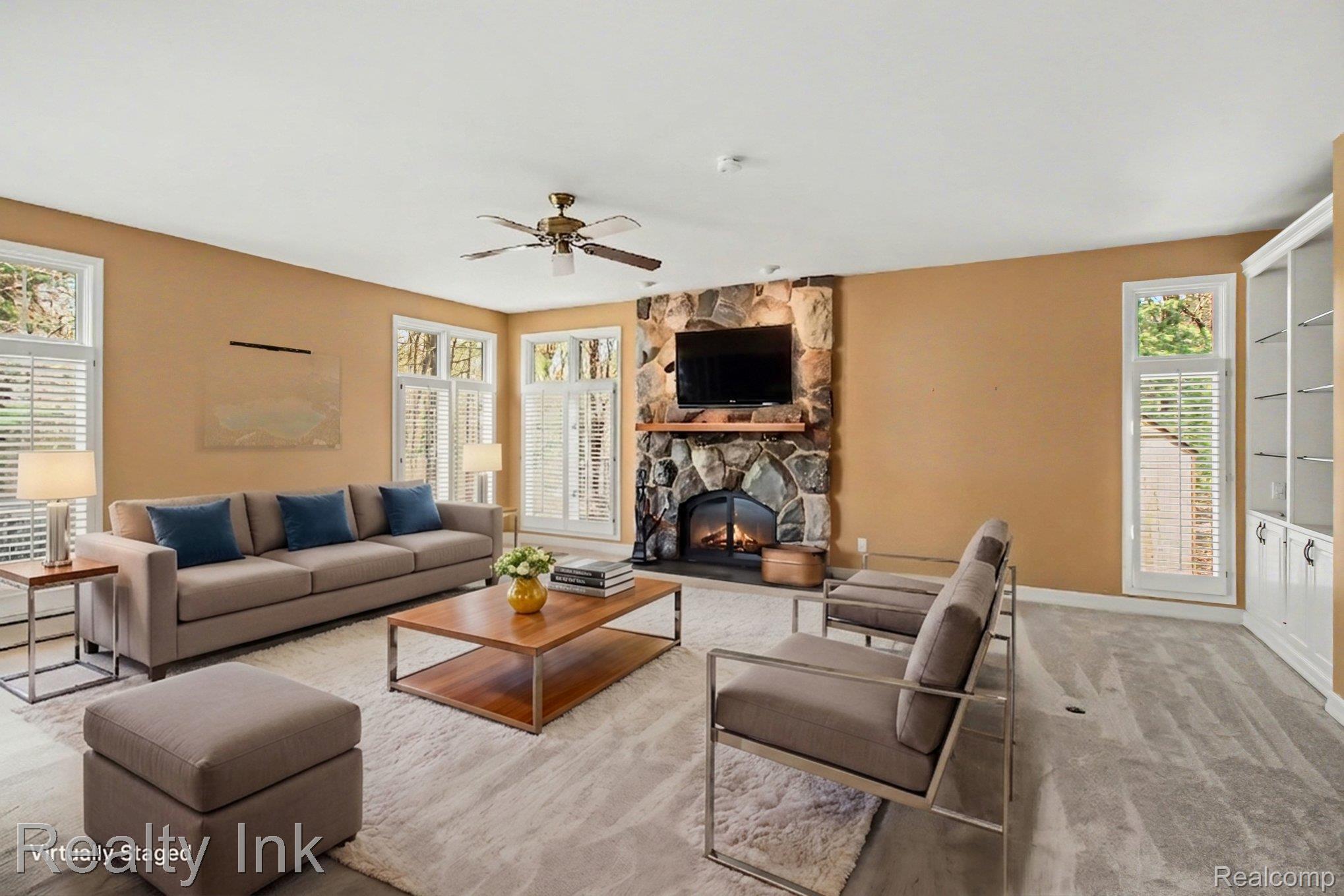 4927 Nature View Court Howell, MI 48843 - Photo 9 of 19 Living room with a stone fireplace and a ceiling fan