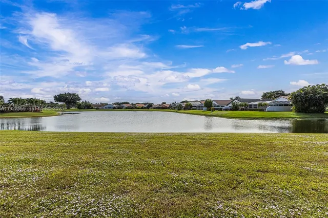 a living room with furniture a rug and kitchen view