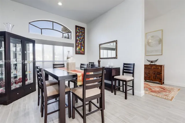 a kitchen with granite countertop white cabinets and stainless steel appliances