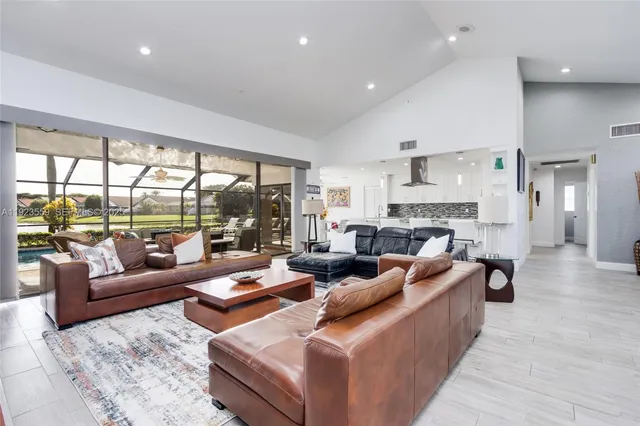 a kitchen with granite countertop white cabinets and sink