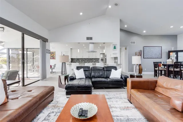 a spacious bathroom with a granite countertop sink and a mirror
