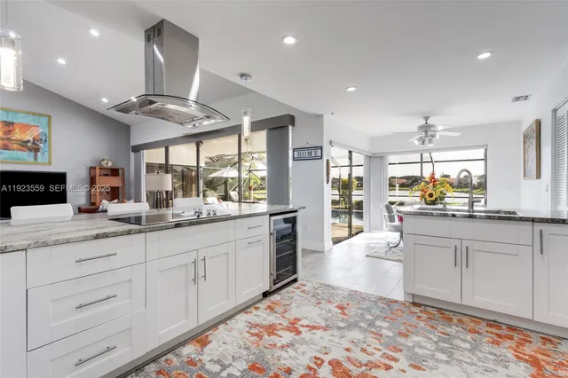 a bathroom with a granite countertop sink mirror and shower