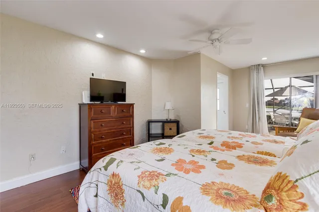 a bedroom with a beds window and a flat screen tv