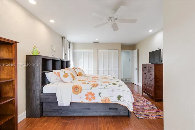 a spacious bedroom with a bed and a chandelier