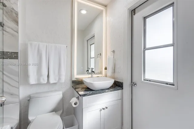 a patio with a table and chairs under an umbrella