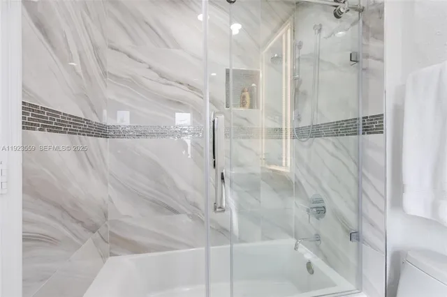 an aerial view of residential houses with outdoor space and pool