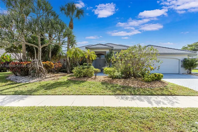 a view of a swimming pool with a table and chairs under an umbrella
