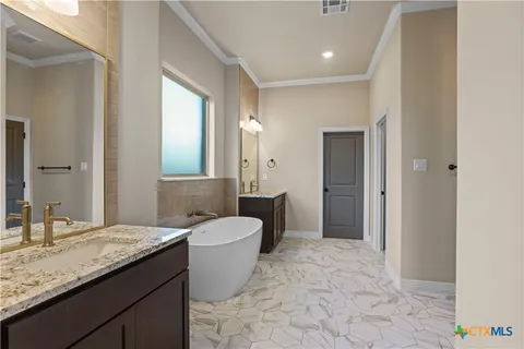a bathroom with a granite countertop sink a toilet and a mirror
