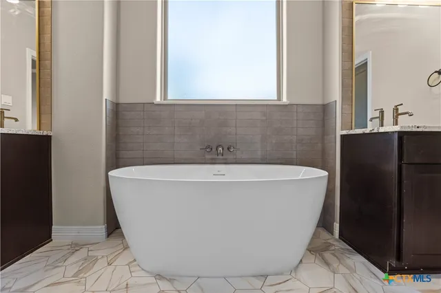a white bath tub sitting in a bathroom
